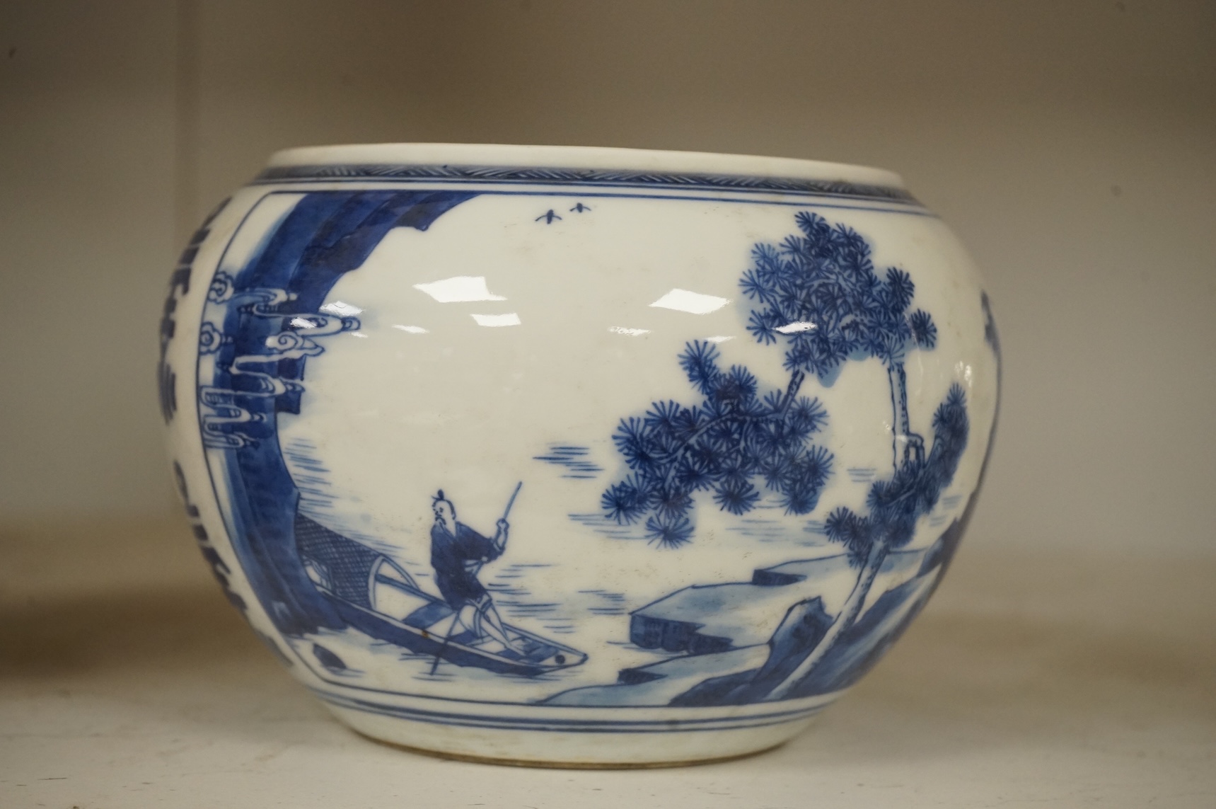 A Chinese blue and white water pot, decorated with two scenes in landscapes, 10.5cm high